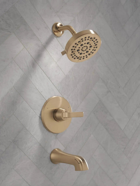 Top Shelf 5 Setting Bathtub Shower Faucet Trim Kit In Brushed Gold with showerhead and tub spout on a tiled wall.