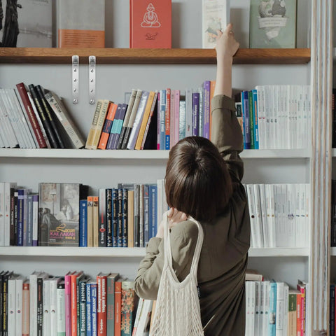 Bookshelf with books and 4 Pcs Stainless Steel Corner Brackets with right angle design and countersunk mounting holes visible.