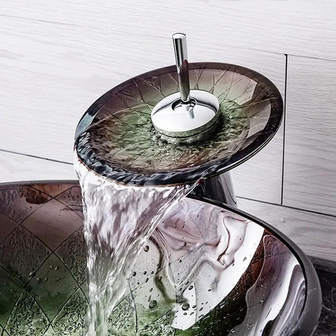 Slick Tempered Glass Bathroom Vessel Sink With Hardcore Waterfall Faucet showing waterfall spout with flowing water, close-up view.