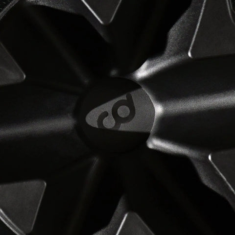 Close-up of a front wheel riser block center with logo, for indoor bike trainers with three height levels and non-slip surface.