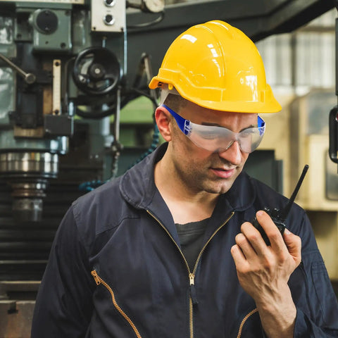 100 Pack Bulk Safety Glasses Featuring Bully Proof Polycarbonate Lenses And Heavy Duty Scratch Protection For Job Sites And Weekend Rigs Rainbow Mix Set worn by a worker with a yellow hard hat.