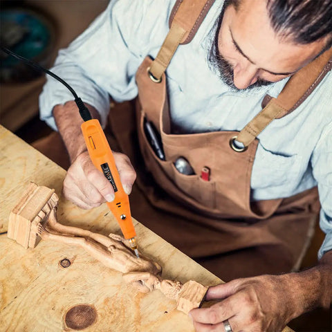 Man using Corded Rotary Tool Kit With 105 Accessories, Mini Power Tool 18000 RPM for engraving wood on workbench