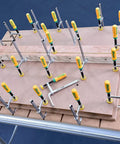 Matchfit Dovetail Clamp Bundle 4 Pack Exclusive DVC-538MB-50 With One Half Inch Dovetail Router Bit in use on wooden tabletop