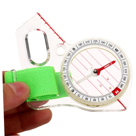 Thumb Type Directional Compass For Outdoor Navigation, Portable Hiking Tool in durable acrylic with a green strap, close-up view