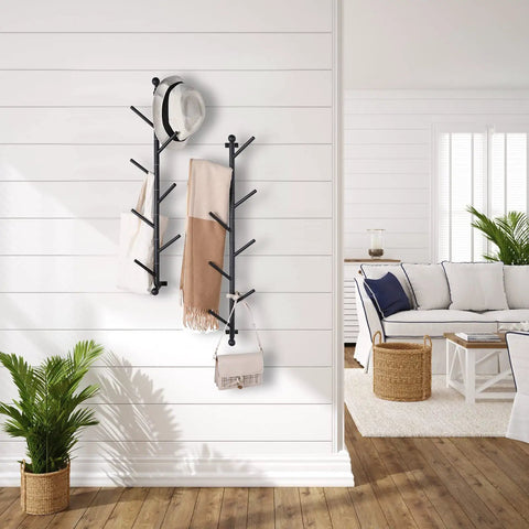 2 Pack Dope Wall Mounted Coat Rack With Rotating Hook Branches in a living room, holding hat, scarves, and bag