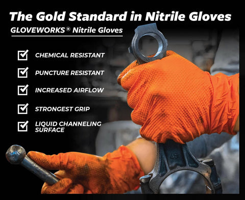 GLOVEWORKS orange nitrile mechanic gloves with raised diamond grip; close-up of gloved hands gripping a metal tool.