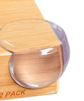 Transparent PVC corner guard on wooden table edge from 12 Pack of Thickened Corner Guards For Baby Proofing Tables, Safe Impact Resistant Cushions For Toddlers, Easy Install, Reusable Baby Proofing Safety Kit.