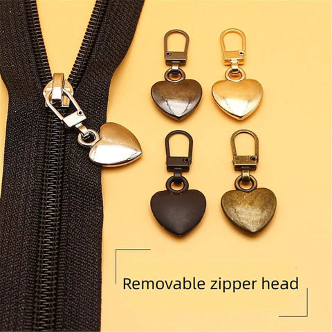 Multicolor Heart Shaped Zipper Pull Replacement Kit For Backpacks Coats Jackets Pants And Luggage 5Pcs Metal Zipper Fixer Repair Set With Durable Pulls And Sewing Notions For Easy Quick Fixes On The Go shown with four metal heart-shaped pulls and a zipper.