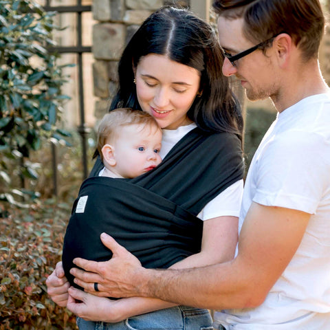 Parents using D Lite Baby Wrap Carrier Ring Sling For Newborn To Toddler With Easy Adjust Ergonomic Comfort And Breathable Fabric outdoors