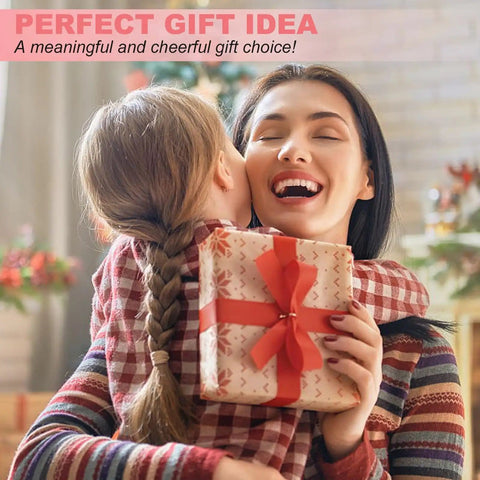 Woman hugging child while holding gift with red ribbon indoors.