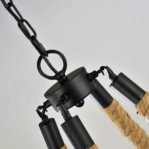 Rock Solid Industrial Chandelier Features Woven Hemp Rope And Sturdy Metal Candle Holders To Set A Chill Farmhouse Vibe, close-up of fixture with black hardware.