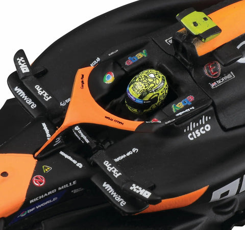 Close-up of McLaren MCL38 1:43 Scale 2024 Die-Cast Formula Car cockpit with helmet, showing realistic decals and driver details.