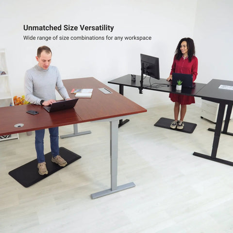 L Shaped Electric Standing Desk Acting As A Game Changer For Your Home Office With Roomy 72 By 60 Inch Corner Layout To Roll Out Multiple Screens And Set Up Shop In Sturdy Gray Frame And Beech Top with two users working.