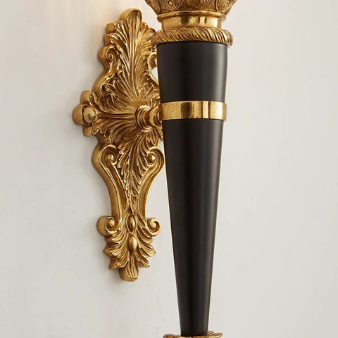 Solid Copper Wall Sconce Clear Textured Glass Shade Matte Black With Brushed Gold Trim Heavy Duty Indoor Lighting Fixture For Primary Bedroom Living Space Hallway Entryway Straight Fire Glow detailed view of gold-trimmed black wall sconce.