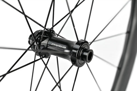 Close-up of Carbon Disc Wheelset 50C Tubeless Center Lock With Front 12x100 And Rear 12x142 Thru Axles Black Finish hub