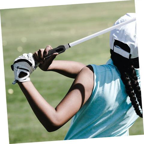 Golfer using Golf Grip Trainer Pro Grade Swing Training Device for consistent swings and alignment on a sunny golf course.