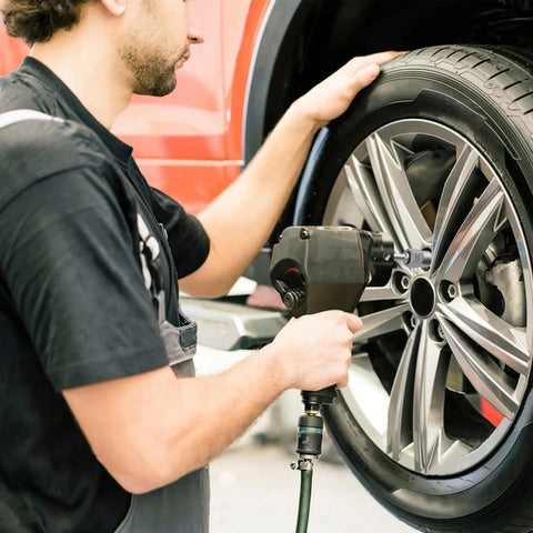 Mechanic using a Bolt Extractor Set for Stripped Nuts, 3/8 Inch Square Drive, Heavy Duty 41Cr4 Steel on car wheel