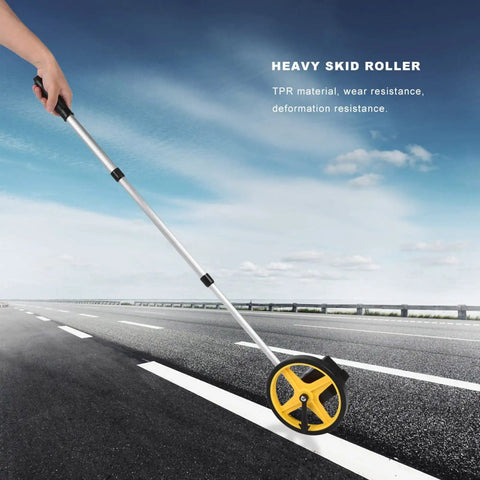 Luocute Mechanical Distance Measuring Wheel 0 to 9999.9m (small wheel) being used on a road with an adjustable handle for ease.