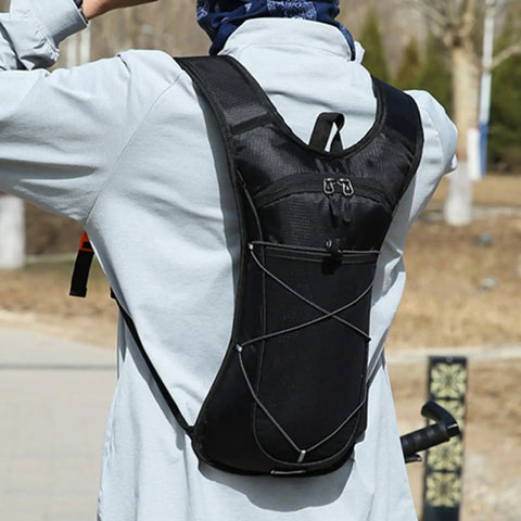 Person wearing Hydration Backpack With Nylon Reservoir And Reflective Strips, Lightweight, Weatherproof Nylon Pack for outdoor adventures