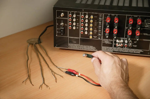 Remote And Local Continuity Tester With Detachable Remote Probe in use for long distance cable testing and tracing setup on a desk