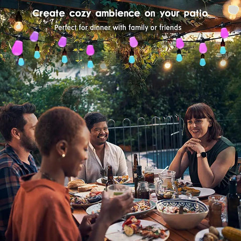 Friends dining under Solar Powered Outdoor String Lights 27ft RGB Color Changing, Dimmable Edison Bulbs, Smart Patio Lighting.