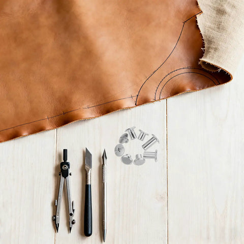 Badass Durable 110 Pack Leathercraft Screw Rivets And Gnarly Heavy Duty Metal Fasteners For Wallet Stitching And Journal Repairs Featuring A Hella Neat Sortable Case To Keep Your Crafting Session Tight on a leather crafting workspace.