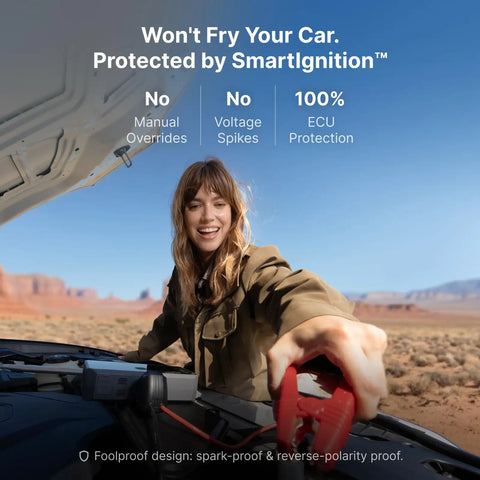 Woman using M7 SmartIgnition Jump Starter With Air Compressor on car engine in desert landscape.