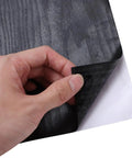 Self Adhesive Wallpaper Roll For Cabinets Sleek Black Waterproof Pvc Vinyl Wrap Realistic Wood Texture being peeled back to stick.