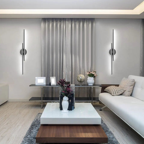 Living room with wall-mounted dimmable modern LED vanity light fixtures, black finish, 31.5 inch, adjustable brightness.