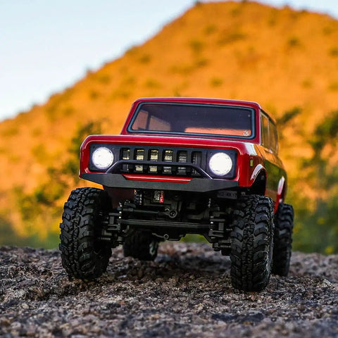 Redcat Racing Ascent 18 Scout II Brushless 4x4 One Eighteenth Scale RC Crawler with red body on rocky terrain