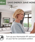 Woman adjusting thermostat with 42 Inch Newsome Premier Bronze Low Profile Ceiling Fan With LED Light Kit in living room.