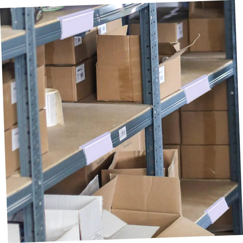 Heavy Duty PVC Wire Shelf Label Holders 30 Pack Clear Display Fronts on shelves organizing cardboard boxes.