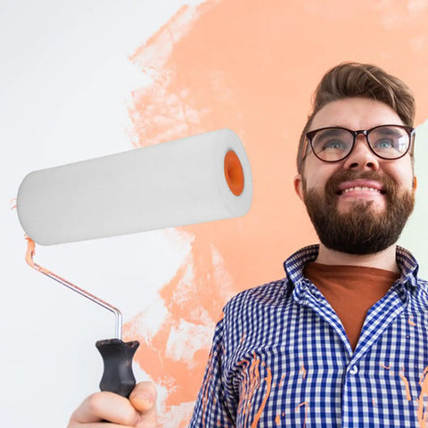 Master Your Next Painting Job With These Flexible Sponge Paint Roller Sleeves Perfect For Cabinets Walls And Tight Spaces That Slather On Smooth Finish Fast While Chasing Down Every Drip To Save You Serious Labor On Smart Home Fixes, featuring a foam roller with a handle held by a man in front of an orange-painted wall.