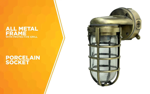 Industrial 100W Incandescent Wall Mount Light in Antique Brass with protective cage and metal die cast construction