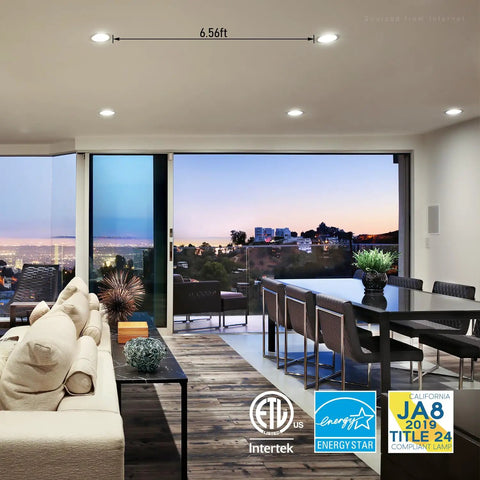 Slick Six Inch Slim Recessed LED Downlight Kit illuminating modern living room with city view, satin nickel finish.