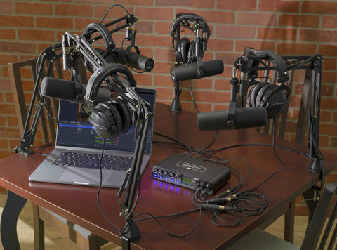 USB-C 6x4 Audio Interface With Pro-Grade Studio-Quality Sound And ESS Sabre32 DAC, 120 dB Dynamic Range on a podcast setup table.