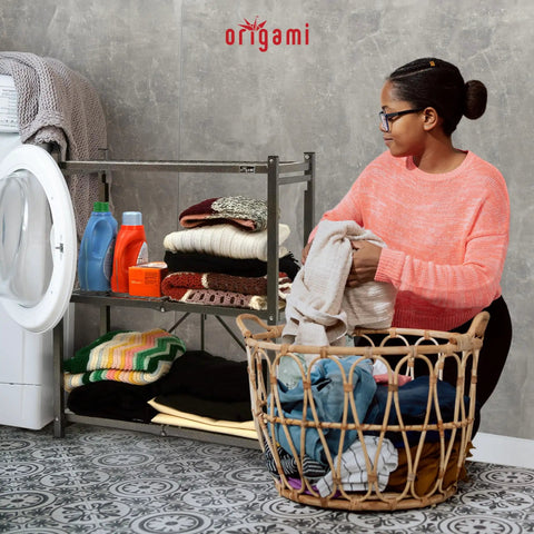 Three Tier Foldable Storage Shelf On Wheels, Pewter Finish in laundry room with folded clothes and basket.