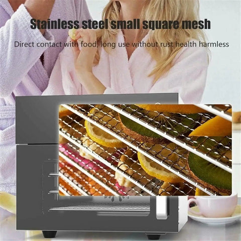 Stainless Steel Four Layer Electric Food Dehydrator With Adjustable Thermostat displaying dried fruit on mesh trays.