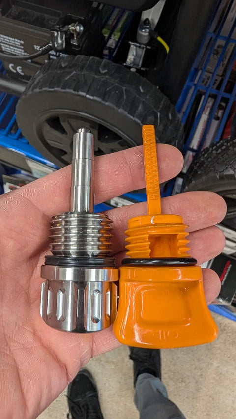 Hand holding a Magnetic Oil Dipstick For Predator 8750 9000 9500 13000 Generators, 27mm Threads, Stainless Steel next to plastic dipstick.