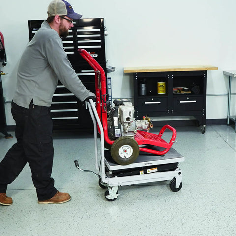 User pushing a Heavy Duty Hydraulic Table Cart With Fast Two Speed Lift And 1000 LB Capacity Built Tough For Garage Projects.