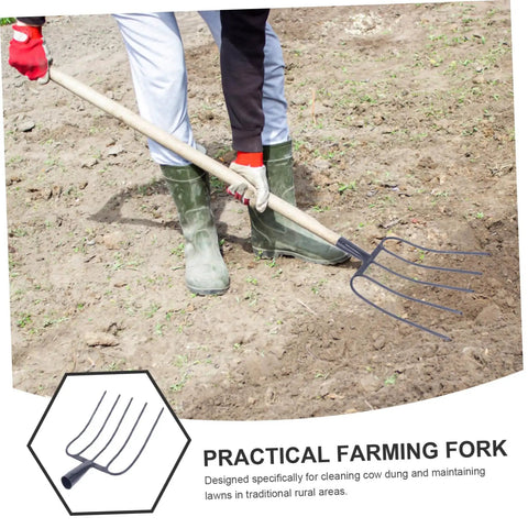 Person using Sturdy Iron Manure Fork Handle For Horse Tools And Lawn Care on dirt, dark blue iron, long wooden handle.