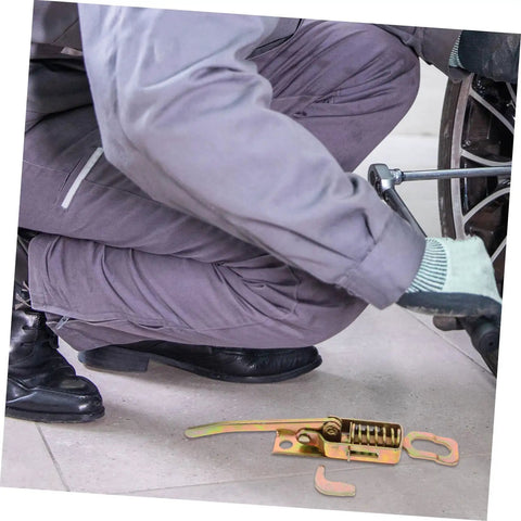 Mechanic kneeling by wheel near Heavy Duty Truck Toolbox Door Latch Kit With Adjustable Metal Hooks And Spring Hand Buckle on floor