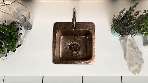 Top view of 15-Inch Baxter Drop-In Pure Copper Bar Sink With Hand-Hammered Finish installed in a kitchen countertop.
