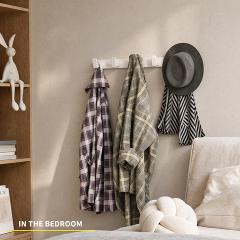 Heavy Duty Wall Mount Coat Rack Featuring Five Lock Down Hooks For All Your Everyday Essentials Like Hats Keys Wallets And Bath Towels Crafted From Corrosion Proof Aluminum In Crisp White Two Pack Bundle with jackets and a hat in a bedroom setting.