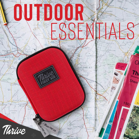 Thrive mini first aid kit pouch, red fabric with black label, front view on map