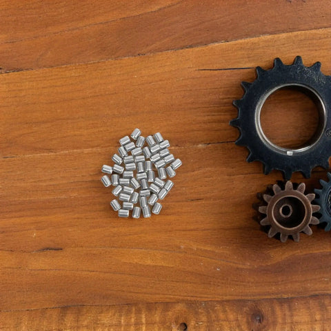 50pcs Heavy Duty Stainless Steel Dowel Pins for Furniture Install and Shelf Support on wooden surface with gears.