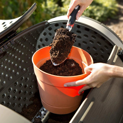Close-up of Double Bin Rotating Composter With Two 50 Gallon Barrels For Nonstop Composting being filled with soil