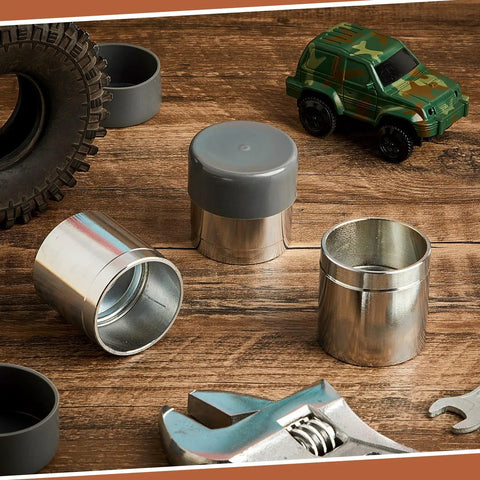 Heavy Duty Four Piece Trailer Wheel Bearing Protectors With Chromed Metal Dust Caps on wood surface with tools and toy car.