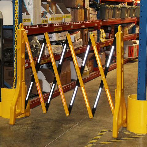 8 Ft Folding Traffic Barrier Fence With Reflectors, Portable Construction Barricade in warehouse setting, partially expanded