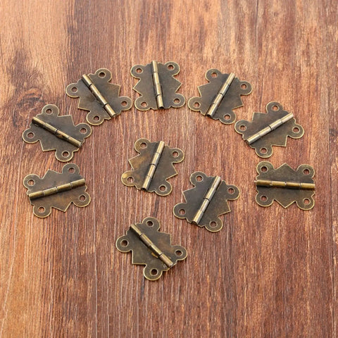Mini Butterfly Door Hinge Set Antique Bronze 20 By 25mm 20 Pieces displayed on wooden surface